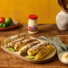 Grilled corn on the cob with McCormick Mayonnaise lime wedges and a side of mayonnaise.
