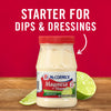 A jar of McCormick Mayonesa Mayonnaise with lime juice on a wooden table with a lime wedge.
