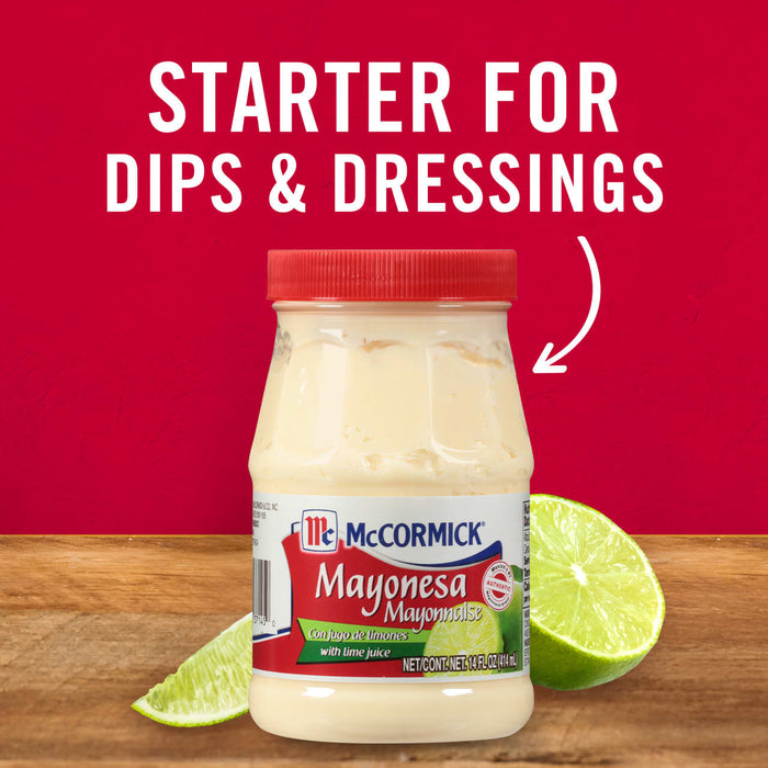 A jar of McCormick Mayonesa Mayonnaise with lime juice on a wooden table with a lime wedge.
