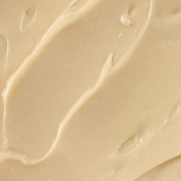 Close up of a creamy beige colored lotion.