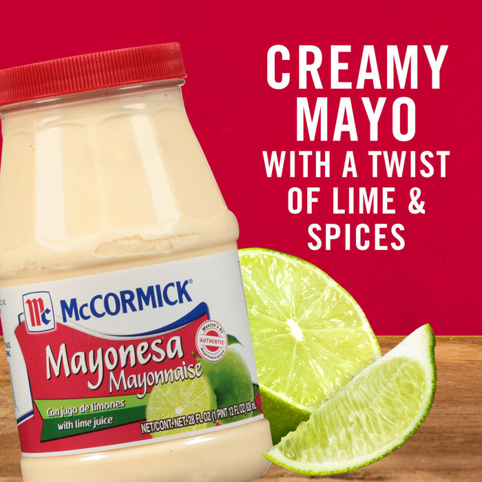 A bottle of McCormick Mayonesa with lime wedges on a wooden table.