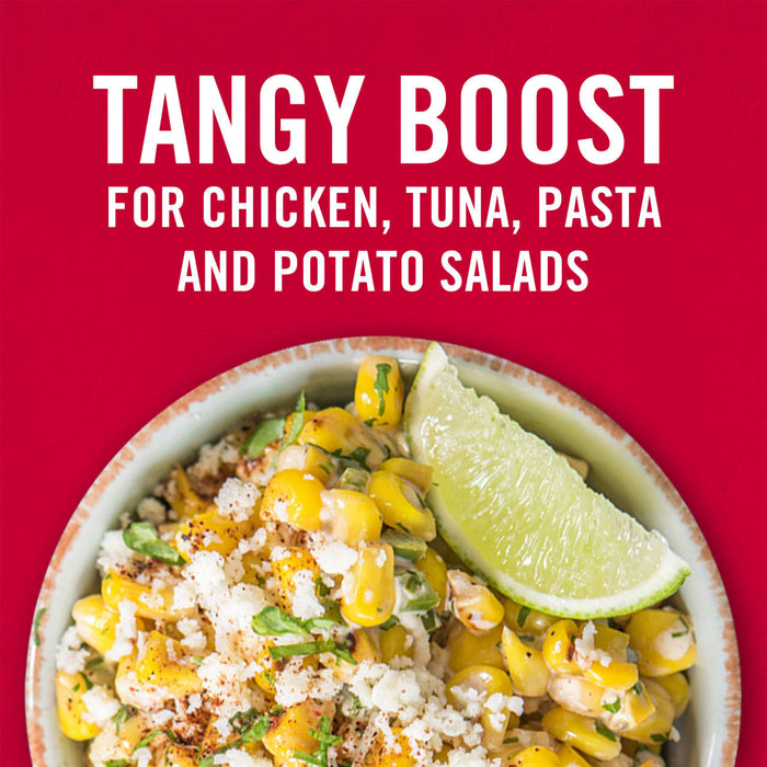 A bowl of corn salad with a lime wedge on top with the text Tangy Boost for Chicken Tuna Pasta and Potato Salads above it.