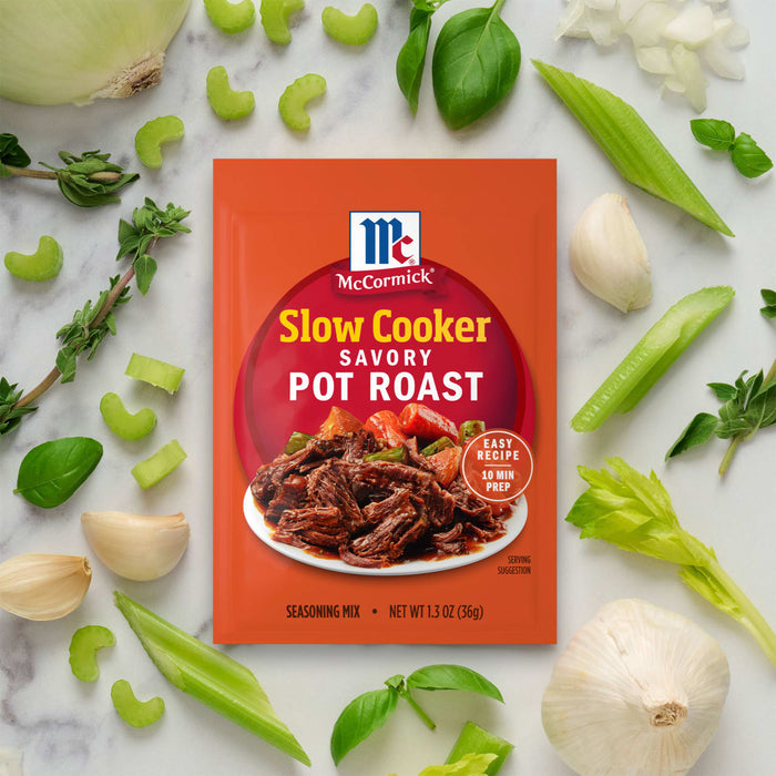 McCormick Slow Cooker Savory Pot Roast seasoning packet surrounded by fresh vegetables.