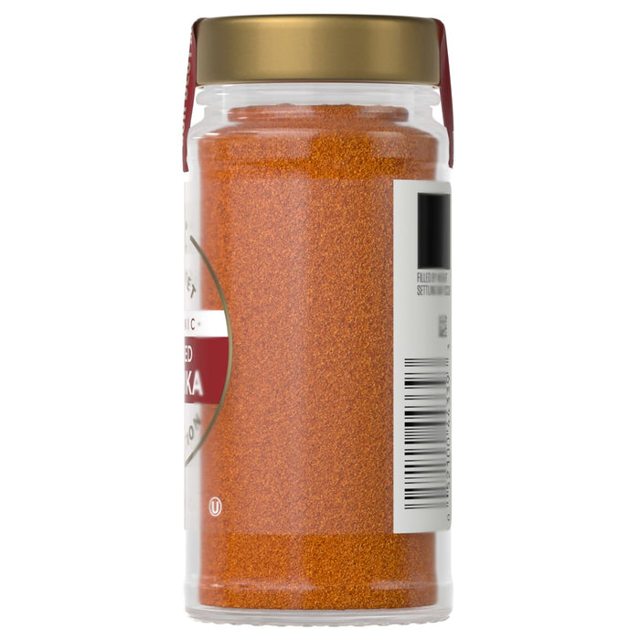 A jar of Simply Organic Smoked Paprika is shown, filled with a vibrant red spice and sealed with a gold lid.