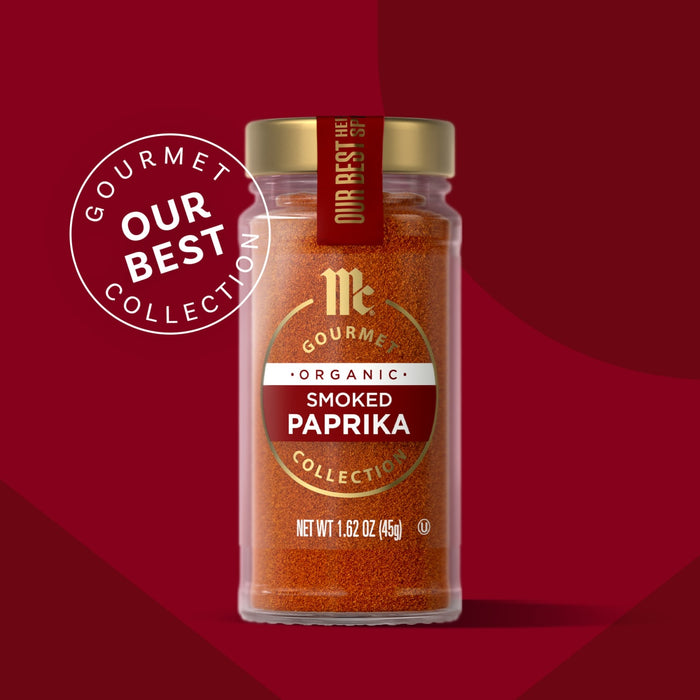 A jar of Mccormick Gourmet Smoked Paprika Organic 1.62 Oz, part of the Our Best Collection, stands against a red background.