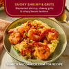 A plate of McCormick's Smoky Shrimp and Grits features blackened shrimp, cheesy grits, and crispy bacon lardons.