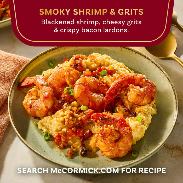 A plate of McCormick's Smoky Shrimp and Grits features blackened shrimp, cheesy grits, and crispy bacon lardons.