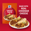 McCormick Cheesy Taco seasoning mix is shown with prepared tacos, highlighting that it's made with real cheddar cheese.