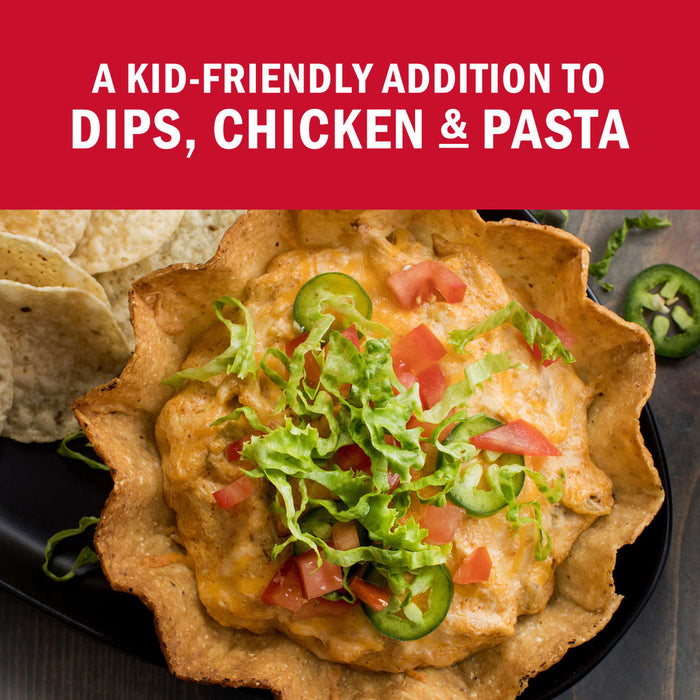 A kid-friendly dip with chicken and pasta, topped with lettuce, tomatoes, and jalapeños, served in a tortilla bowl with tortilla chips.