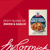 A packet of Mccormick Toasted Onion And Garlic Seasoning Mix 1.25 Oz is featured in a marketing image with a bowl of roasted potatoes on the label and a red background.