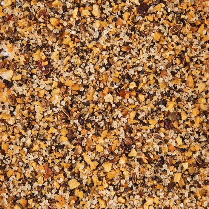 A close-up of a mixture of salt pepper and other spices.