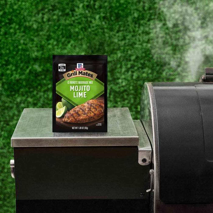 A McCormick Grill Mates Mojito Lime seasoning packet sits on a grill, suggesting its use in outdoor cooking.