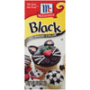 McCormick Black Food Color bottle with cupcakes decorated with black icing.