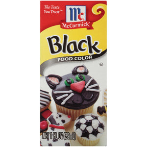 McCormick Black Food Color bottle with cupcakes decorated with black icing.