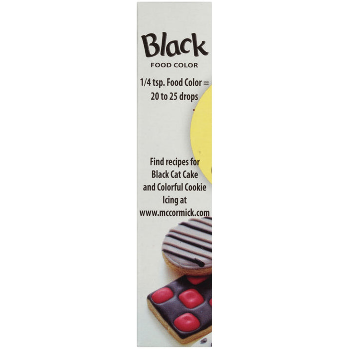 McCormick Black Food Color bottle with a cookie decorated with black icing.