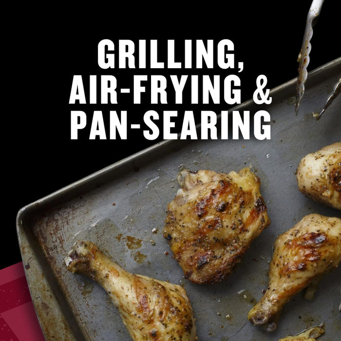 A close-up of grilled, air-fried, and pan-seared chicken pieces on a baking sheet.