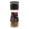 A McCormick Pepper Mill Grinder filled with peppercorns.