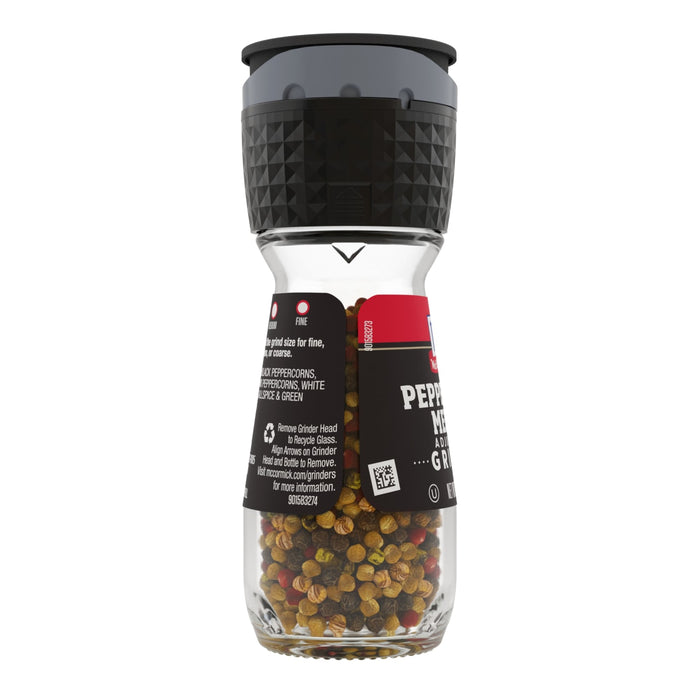 A McCormick Pepper Mill Grinder filled with peppercorns.