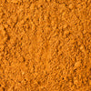 A vibrant orange-brown pile of Mccormick Chicken Taco Seasoning Mix, showcasing its fine, granular texture.