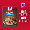 A packet of McCormick Brown Gravy mix is displayed next to a plate of mashed potatoes, green beans, and sliced meat covered in gravy, with the McCormick logo and the tagline The Taste You Trust.