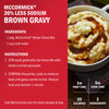 A package of McCormick 30% Less Sodium Brown Gravy mix with instructions for preparation and a photo of the finished gravy served over mashed potatoes.
