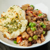 A hearty serving of shepherd's pie with a generous topping of mashed potatoes and a rich meat and vegetable filling.