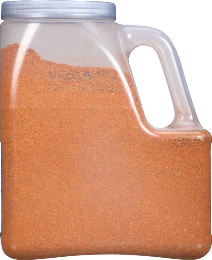 A plastic container filled with a red and orange spice blend.