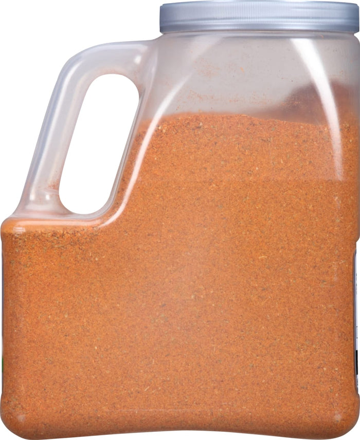 A plastic container filled with a brown spice blend.