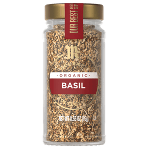 A glass jar of McCormick Gourmet Organic Basil.
