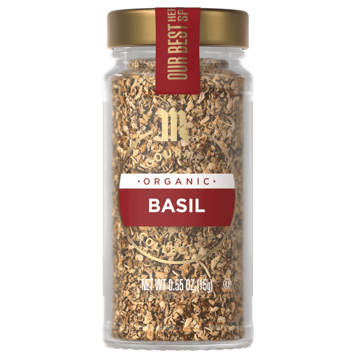 A glass jar of McCormick Gourmet Organic Basil.
