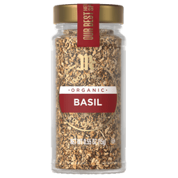 A glass jar of McCormick Gourmet Organic Basil.