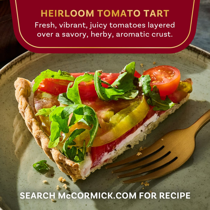 A slice of McCormick Heirloom Tomato Tart featuring fresh tomatoes layered over a savory crust.