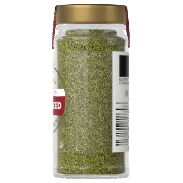A jar of McCormick dried dill weed is displayed showcasing its green color and texture.