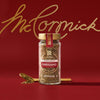 A jar of McCormick oregano is displayed against a red background with the McCormick logo in gold.
