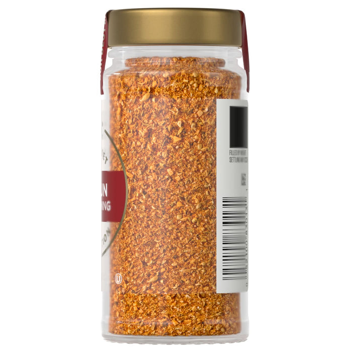 A jar of Cajun seasoning with a gold lid and a label with a barcode.