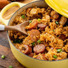 A yellow pot filled with jambalaya a Cajun and Creole dish made with rice chicken sausage and vegetables.