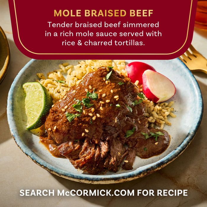 This is an image of McCormick's Mole Braised Beef, a tender braised beef simmered in a rich mole sauce served with rice and charred tortillas.
