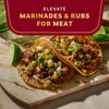 Elevate your meat dishes with flavorful marinades and rubs, as shown in this image of delicious tacos.