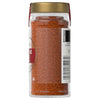 A jar of McCormick Chili Powder is shown, highlighting its vibrant color and texture.