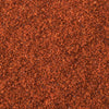 A textured surface with a consistent reddish-brown color, resembling fine granules or sand.