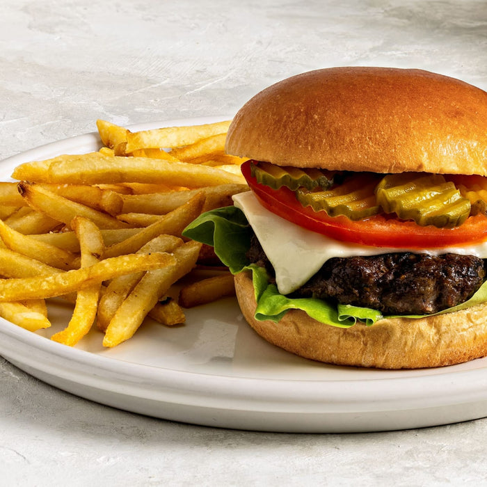 A juicy burger with fries, showcasing a classic American meal.