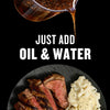 An advertisement featuring a sauce being poured over steak and mashed potatoes, with the text Just Add Oil &amp; Water.