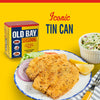 A can of Old Bay Seasoning next to a plate of fried fish with lemon wedges and red onion, and a bowl of coleslaw.