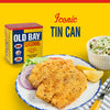 A can of Old Bay Seasoning next to a plate of fried fish with lemon wedges and red onion, and a bowl of coleslaw.