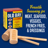 A can of Old Bay seasoning with two wooden mallets, one with the Old Bay logo on it.