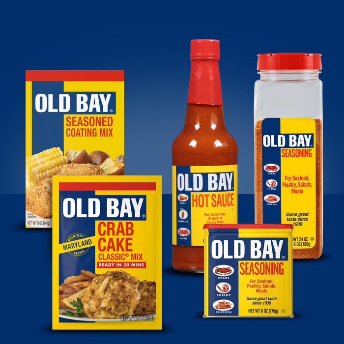 A collection of five Old Bay products including a packet of Old Bay Regular Crab Cake Seasoning Mix 1.24 Oz displayed against a solid blue background.