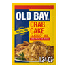 A yellow and blue packet of Old Bay Regular Crab Cake Seasoning Mix 1.24 Oz featuring a photo of prepared crab cakes served with fries and a lemon wedge.