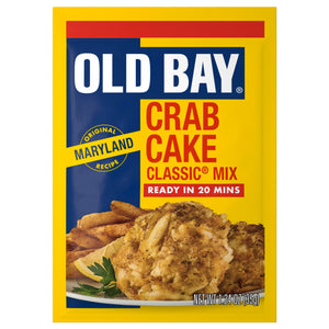 A yellow and blue packet of Old Bay Regular Crab Cake Seasoning Mix 1.24 Oz featuring a photo of prepared crab cakes served with fries and a lemon wedge.