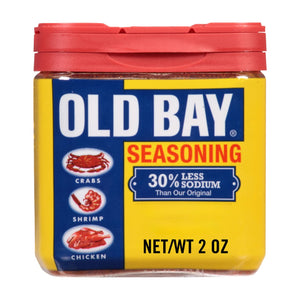A jar of Old Bay Seasoning with a yellow label and a red lid.