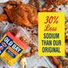 A can of Old Bay Seasoning with a crab on the front, surrounded by crab legs and a yellow sign that says 30% Less Sodium Than Our Original.
